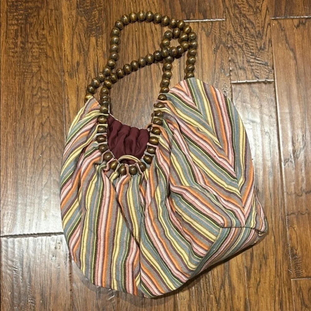 Amici hobo bag with stripe pattern and wooden beaded strap.